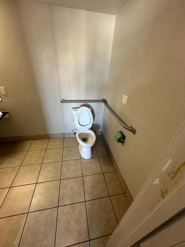 a bathroom with a toilet in a stall at Super 7 inn in Joplin
