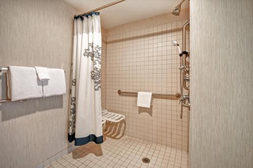 a bathroom with a shower with a shower curtain at Residence Inn by Marriott Stillwater in Stillwater