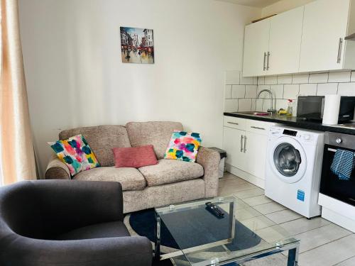 a living room with a couch and a washing machine at Chatham hilltop view in Chatham