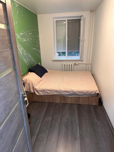 a small room with two beds and a window at Comfy apartment in the center in Chişinău