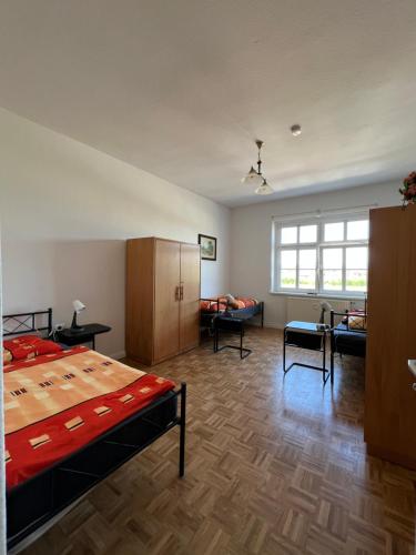a bedroom with a bed and a living room at Sweet Home Inside Dresden Rooms in Dresden