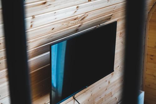 a flat screen tv hanging on a wooden wall at Misty Rocks Kazbegi in Stepantsminda
