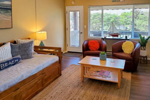 a living room with a bed and two chairs and a table at Neskowin Nautical Nook in Neskowin