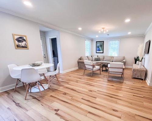 a living room with a couch and a table and chairs at Sleeps 10! Minutes to Parris Island & Downtown in Beaufort