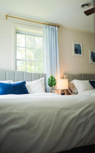 a bedroom with a large white bed with a window at Sleeps 10! Minutes to Parris Island & Downtown in Beaufort
