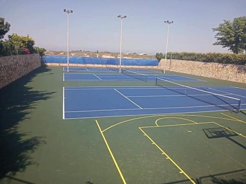 a tennis court with two tennis courts at neot golf kz place in Caesarea