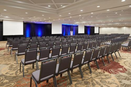 an empty conference room with chairs and a stage at Sheraton Parkway Toronto North Hotel & Suites in Richmond Hill