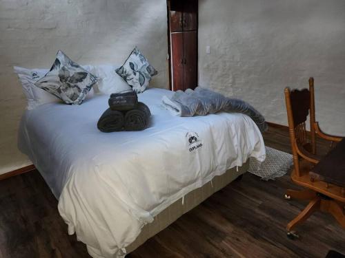 a white bed with towels on top of it at Boomhuis, Mabalingwe Nature Reserve in Bela-Bela