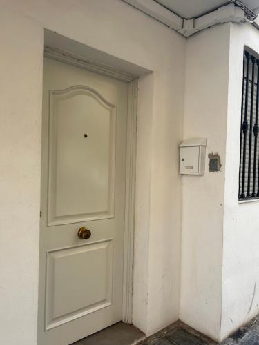 a white door in a white wall with a box at dama iberica II in Valencia
