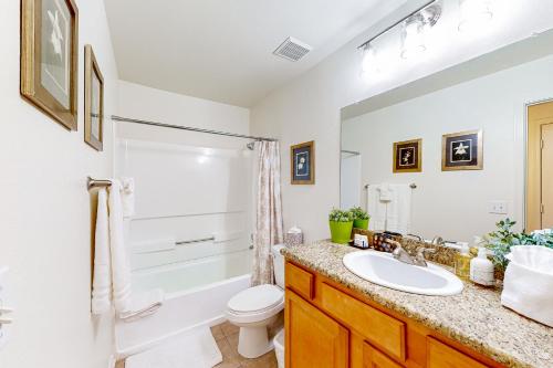 a bathroom with a sink and a toilet and a shower at Live, Work, Play in Ahwatukee in Phoenix