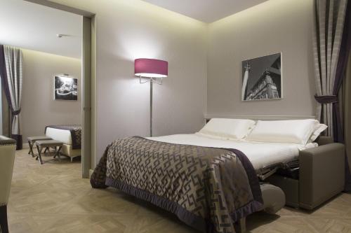 Postel nebo postele na pokoji v ubytování Hotel Spadai