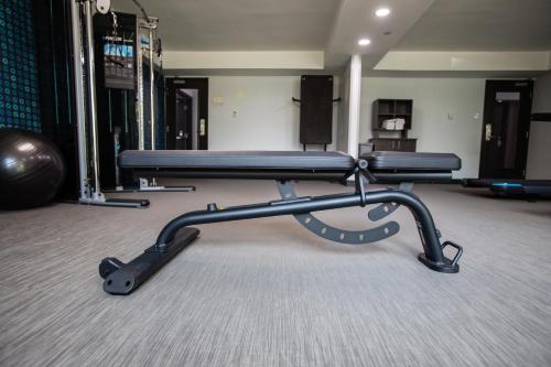 a gym with two benches in a room at La Quinta by Wyndham Dallas I-35 Walnut Hill Ln in Dallas