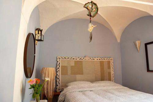 a bedroom with a bed and a mirror at la casa degli Archi in Pesaro
