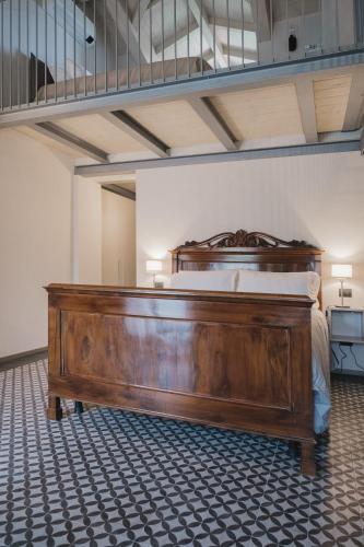 a large wooden bed in a room with at Affittacamere Valèt in San Marzano Oliveto