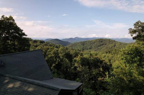 a roof of a house with mountains in the background at The Ridge: A Modern Cabin in Bostic