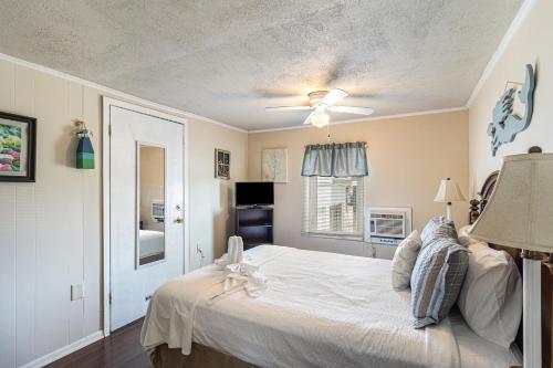 a bedroom with a bed and a ceiling fan at Paradise Perch in Galveston