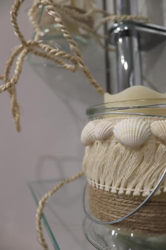 a glass jar with a hat on a glass shelf at Ferienwohnung Hans im Glück in Olbernhau