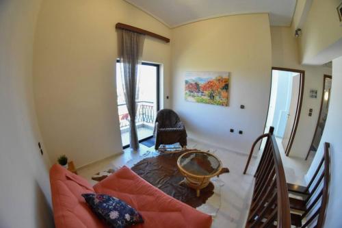 a living room with a couch and a table at Lake Plastira Lodge in Kalyvia