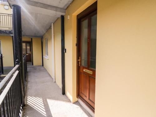 a hallway of a building with a wooden door at 2 Garnish Court in Glengarriff