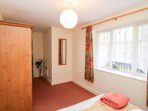 a bedroom with a bed and a window at 2 Garnish Court in Glengarriff