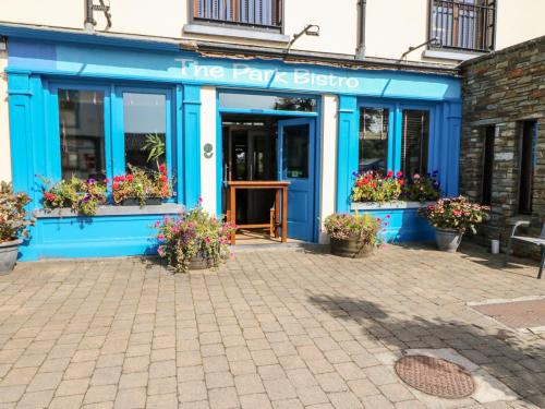 a blue building with flowers in front of it at 2 Garnish Court in Glengarriff