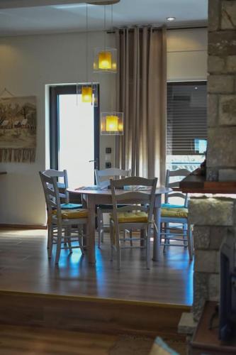 a dining room with a table and chairs at Lake Plastira Lodge in Kalyvia