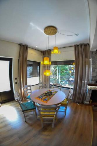 a dining room with a table and chairs at Lake Plastira Lodge in Kalyvia