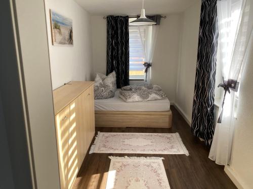 a small room with a bed and a window at Ferienwohnung Pension Sofia 2 in Meißen
