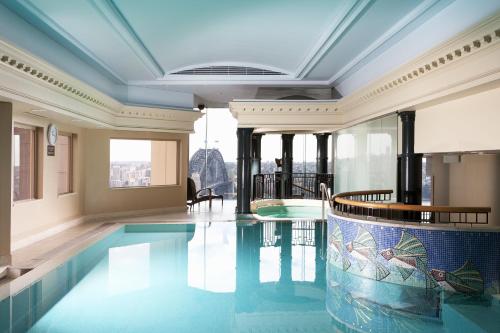 a large swimming pool in a large room at The Sebel Quay West Suites Sydney in Sydney