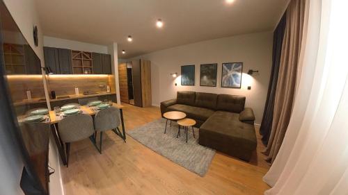 a living room with a couch and a table at Bela Reka C320 Kopaonik Brzece in Brzeće