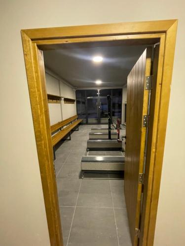 a hallway in a building with a door open at Bela Reka C320 Kopaonik Brzece in Brzeće