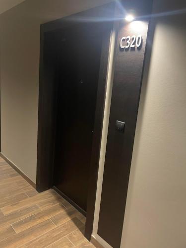 a black elevator with a sign on a wall at Bela Reka C320 Kopaonik Brzece in Brzeće
