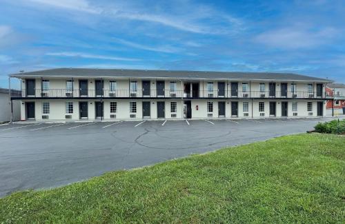 a large white building with a parking lot at America's Best Value Inn Lancaster in Lancaster