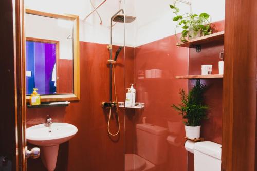 a bathroom with a shower and a sink and a toilet at The Time Machine in Ho Chi Minh City