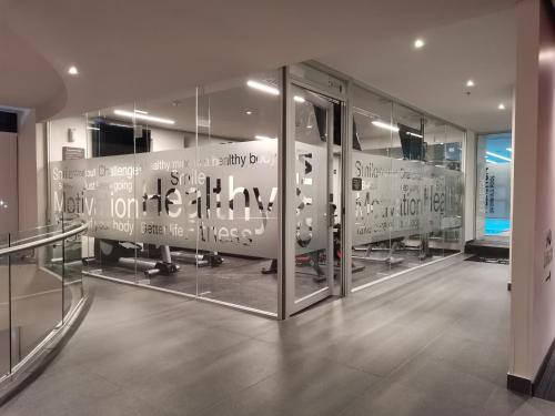 a room with glass doors with writing on it at Ramada Encore by Wyndham Monterrey Apodaca Zona Aeropuerto in Monterrey