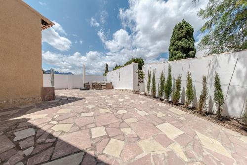 a patio in front of a white fence at Casa Amina in Calpe