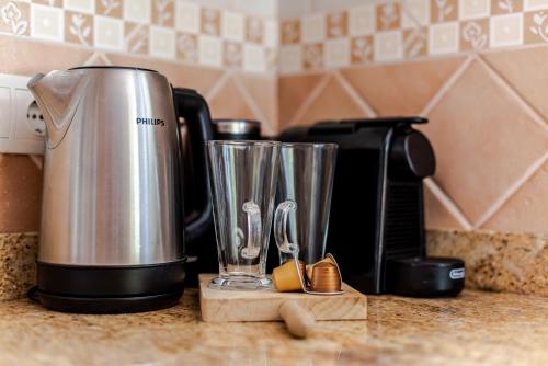 a kitchen counter with a coffee maker on a counter top at Casa Amina in Calpe