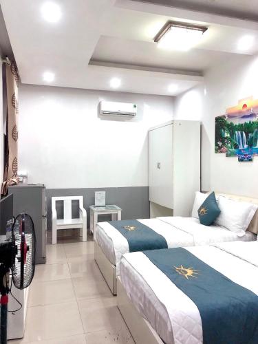 a hotel room with two beds and a television at Holiday Hotel 2 in Hai Phong