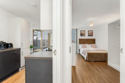 a kitchen and a bedroom with a bed in a room at Khayat Homes - The Luxx - One Bed in London