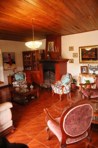 a living room filled with furniture and a fireplace at Posada el portal de la Loma in Pesca