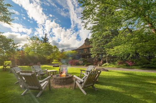 a group of chairs around a fire pit in a yard at Hotel Mountain Brook in Tannersville