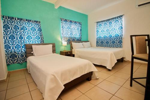 Ένα ή περισσότερα κρεβάτια σε δωμάτιο στο Hotel Casa Ceci Inn