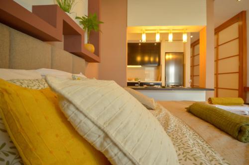 a bed with two pillows on it in a room at NEW Spacious luxury studio in elite neighborhood in Novi Sad