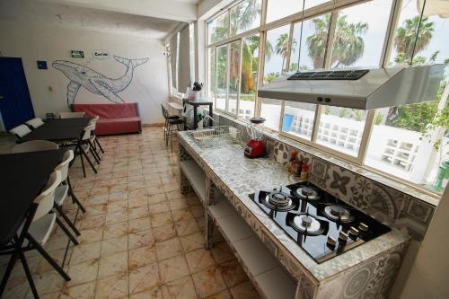 a kitchen with a stove and some windows at Hotel Casa Ceci Inn in San José del Cabo