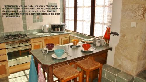 a kitchen with a table with dishes on it at 18 on the Rue in Eymet