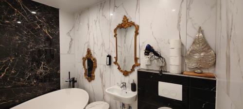 a black and white bathroom with a toilet and a sink at XuBa ApartmentRooms Messe Wien Prater in Vienna