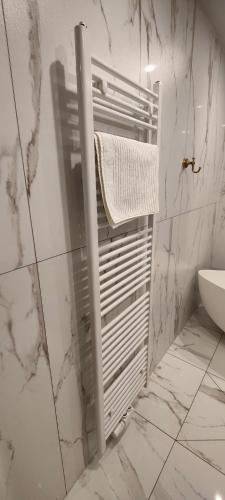 a white towel rack in a bathroom with a sink at XuBa ApartmentRooms Messe Wien Prater in Vienna