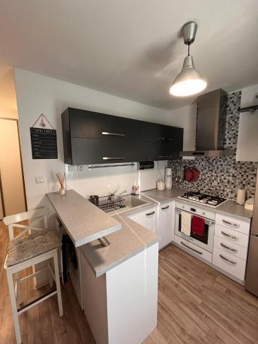 a kitchen with white cabinets and a counter top at Luxury apartman L&A in Košice