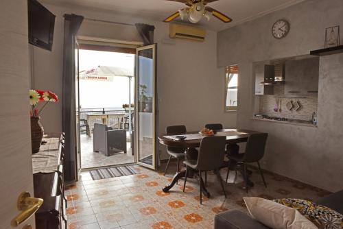 una cucina e una sala da pranzo con tavolo e sedie di BELVEDERE Appartamento per vacanze a Castel di Iudica