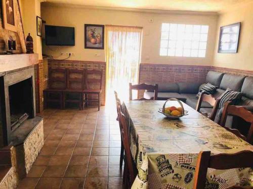 - un salon avec une table et une cheminée dans l'établissement El Aguacate, à Lanjarón